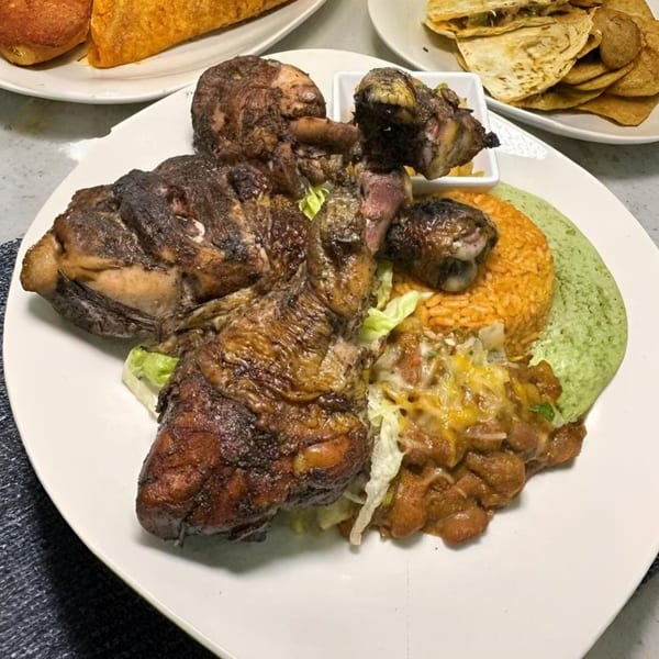 Halal Cuts' grilled chicken with rice, beans, and green sauce, alongside tacos and quesadillas.